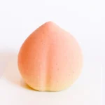 Peach Shaped Pastry 7 A single peach shaped pastry with a natural gradient color on a white card