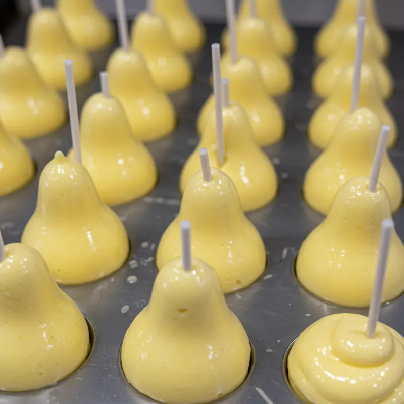 Pear Shaped Ice Cream: Where to Buy it & How to Make it at Home 14 popsicle sticks being added to filled pear shaped molds