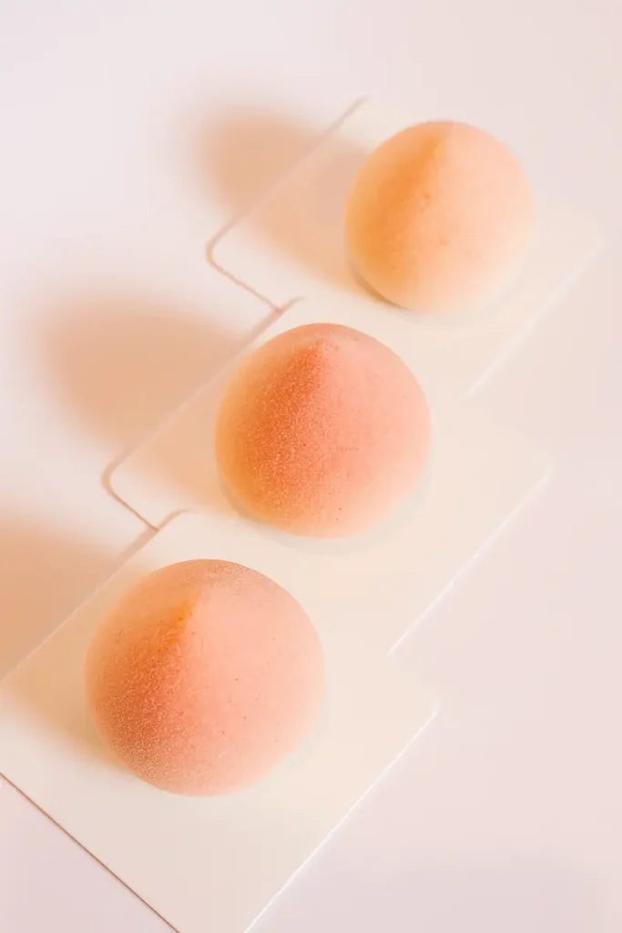 Peach Shaped Pastry 11 Three peach shaped cookies on display cards with soft pink and yellow sugar coating