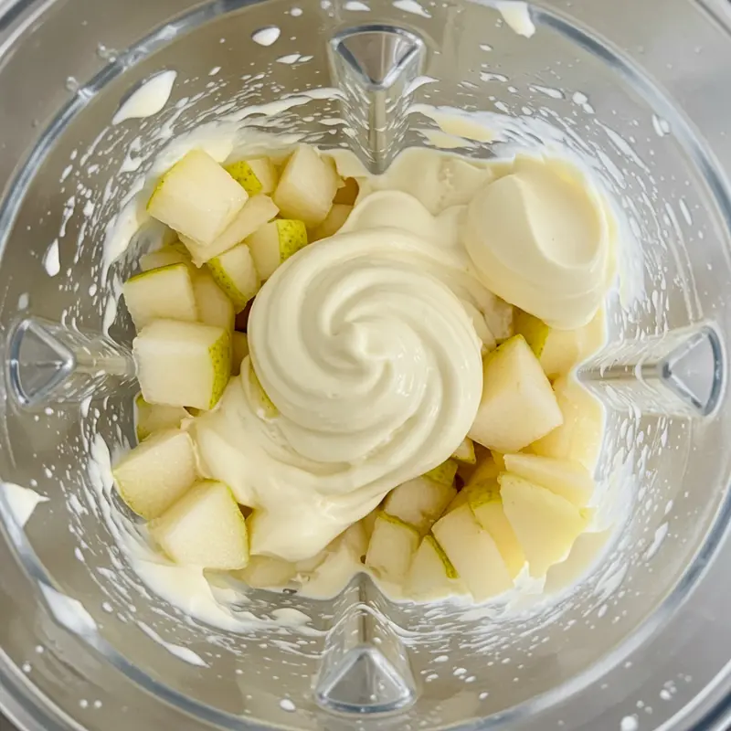 Pear Shaped Ice Cream: Where to Buy it & How to Make it at Home 11 chopped pears blending with cream in a glass blender