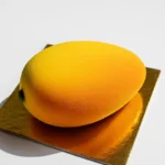 Mango Shaped Pastry 7 Bright mango-shaped dessert with yellow-orange glaze on gold foil