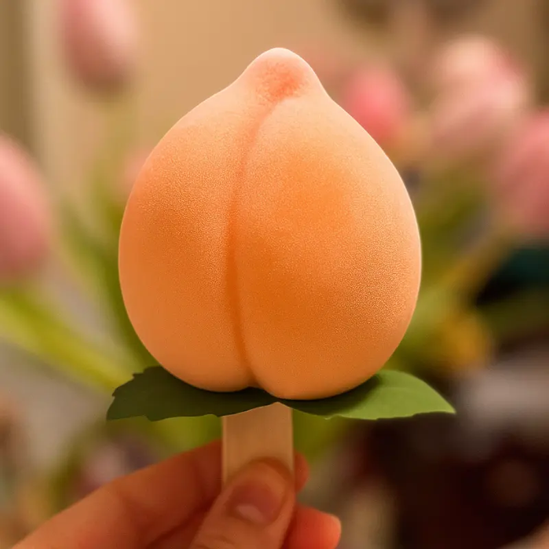 viral peach ice cream held in hand with pastel flower background