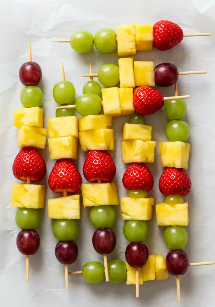 35 Super Easy Snack Ideas for School 2 Colorful rainbow fruit skewers, a healthy and easy snack idea for school.