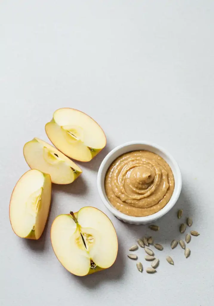 35 Super Easy Snack Ideas for School 6 Crisp apple slices with a side of sunflower seed butter, a simple and easy snack idea for school.