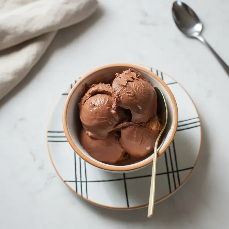 A pint container showing a thick caramel swirl in homemade ice cream, a variation of our ninja creami recipes with pudding mix.