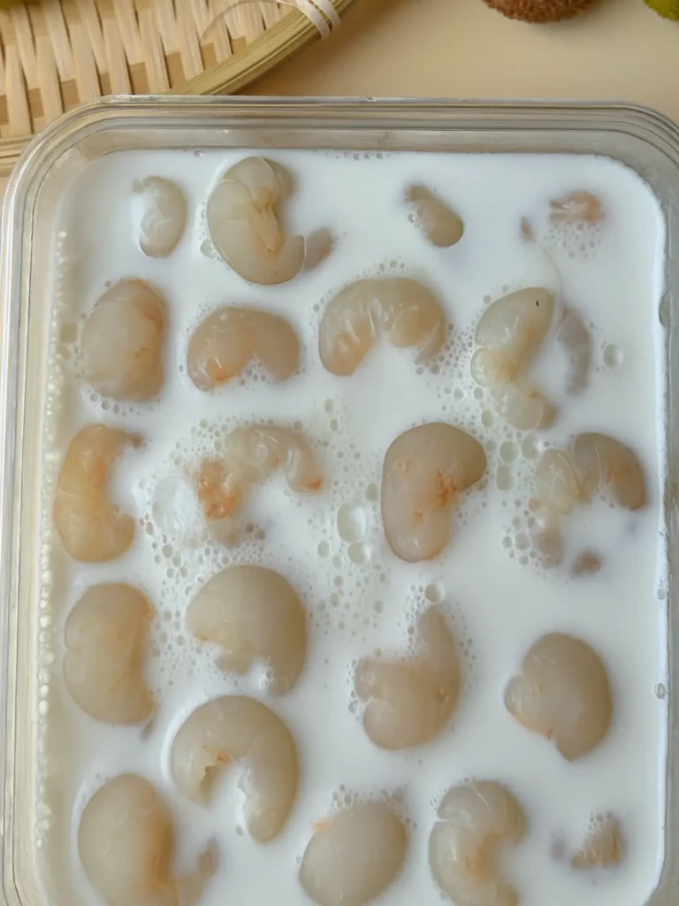 Lychee Panna Cotta Vietnamese Recipe: Easy & Creamy 13 A detailed view of golden-brown toasted almonds garnishing a serving of Vietnamese lychee panna cotta.